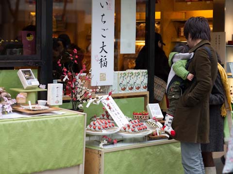 A young family taking a look a the carefully chocolate dipped strawberries.