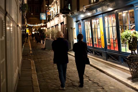 Some friends walking down a side street.