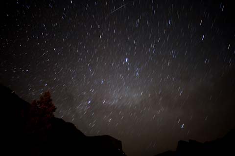 A starry night above the Yosemite Valley.  The small streak, top center, is the skip of a meteor on the atmosphere.