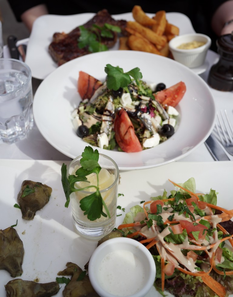 Our order: rib-eye steak with fries, baby artichokes with crème fresh and parmesan, and salad with anchovies, buffalo mozzarella and olives.