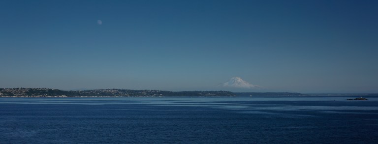 Taking a ferry always offers some unique views for the Puget Sound. If you look closely you can see this summer's Super Moon in the top left side of the frame. Mt. Rainier is still mostly snow-covered at this point in the summer.