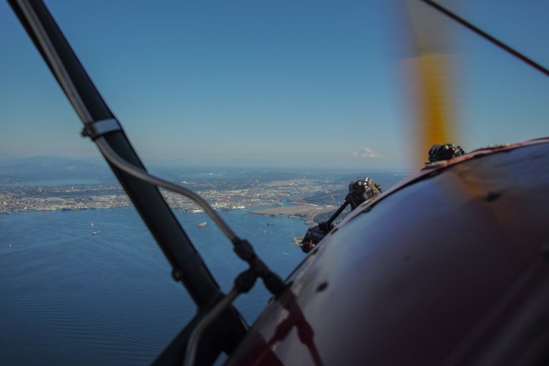 We'll start with something completely different. Although it's not technically looking through an airplane window, because there was no window, it's fits the spirit of this blog post. This is looking over the engine cowling of an old 1937 biplane we flew out of Boeing Field (KBFI) on a tour of Seattle. 