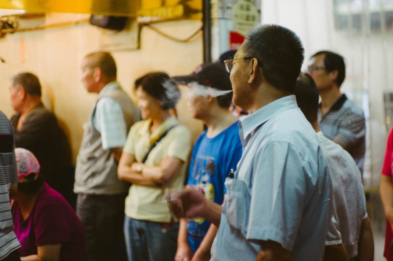 Smoking at a street-side auction. (Leica M9, Canon 50mm LTM, VSCO)